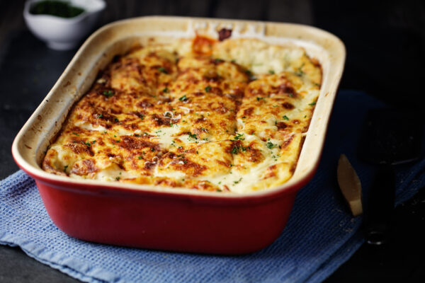 lasagna in dark red baking dish